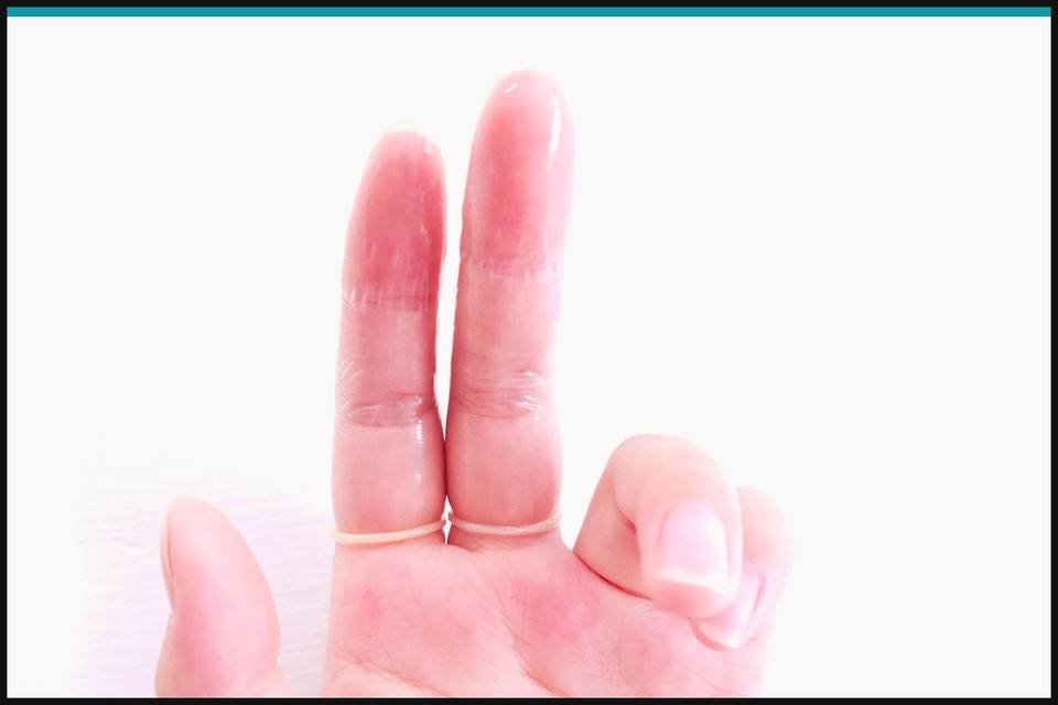 Transparent finger condoms worn one per finger