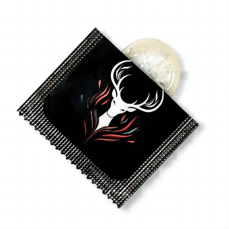 Official Callimis transparent finger condom partly unrolled from a black individual packet